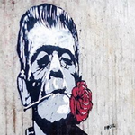 A Banksy-style street art piece of Frankenstein with a carnation in his mouth